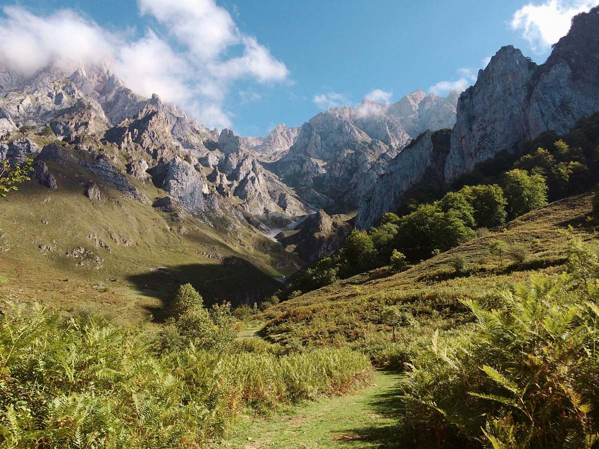 mountain mountain range with green grassy mountainside outdoors