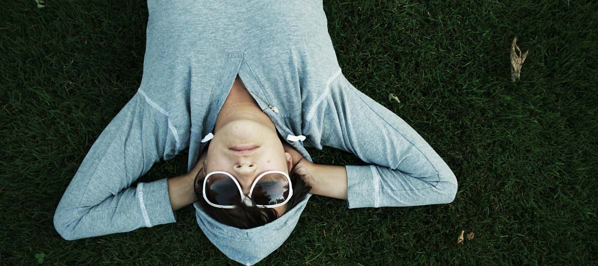 people man lying on grass sunglasses