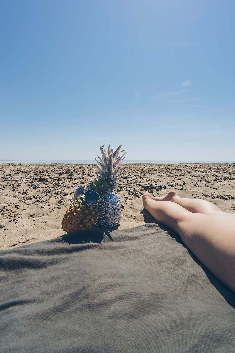 human two pineapple near barefooted person on brown field horizon