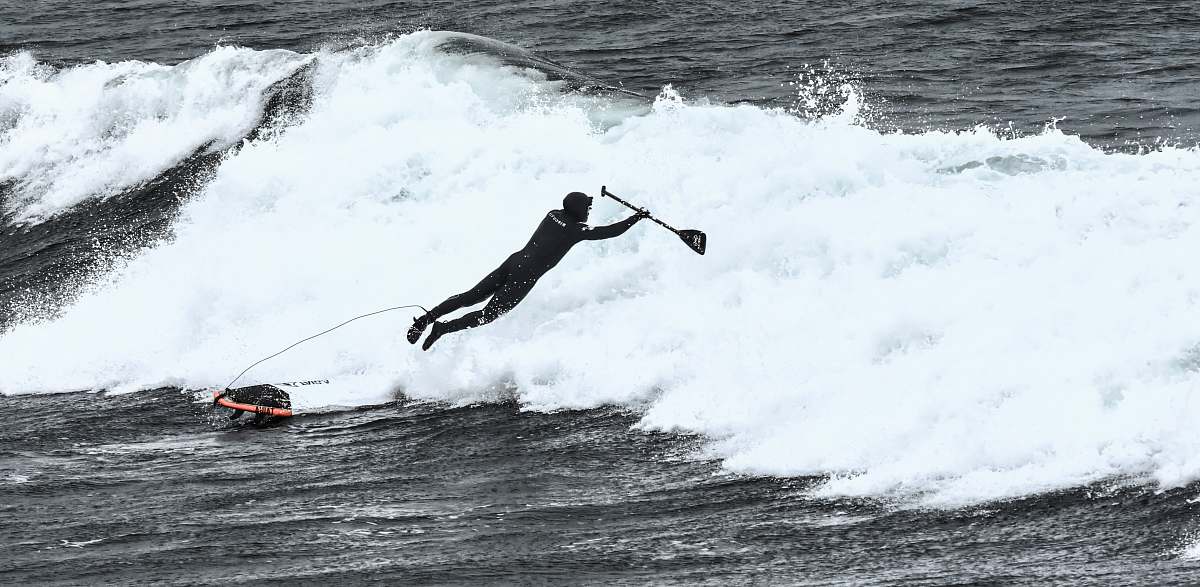 surfing man riding surfboard ocean