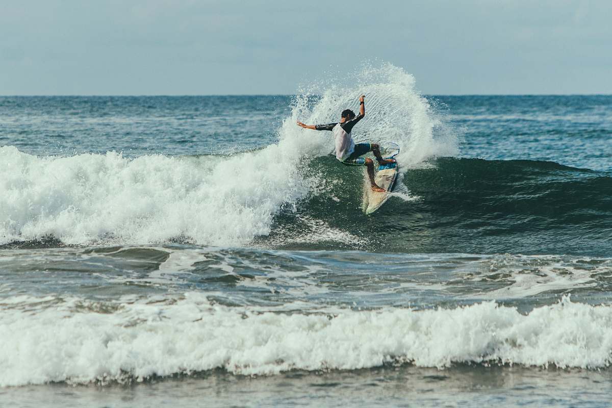 water man surfing on waves during daytime ocean