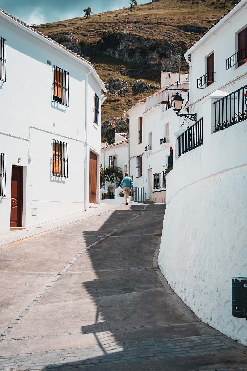 white man walking near houses street
