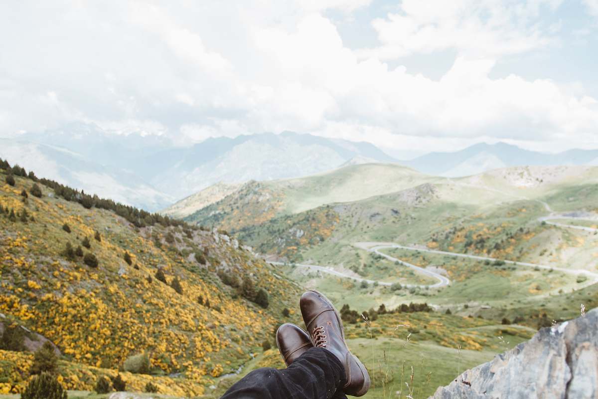 clothing person wearing brown leather boots near mountains at daytime shoe