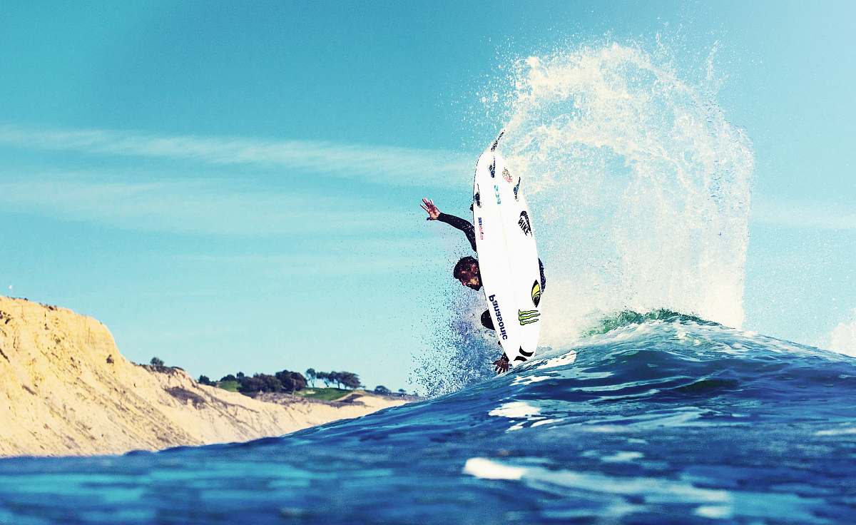 ocean man surfing near land surfboard