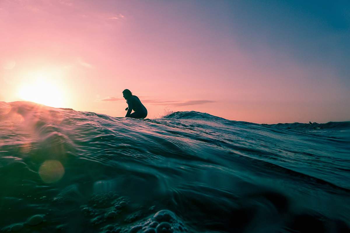 water man surfing on ocean water during golden hour nature
