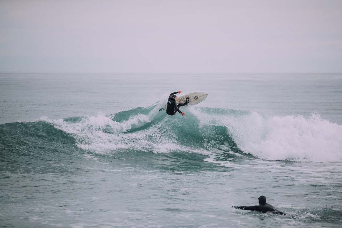 grey person surfing on waves sport