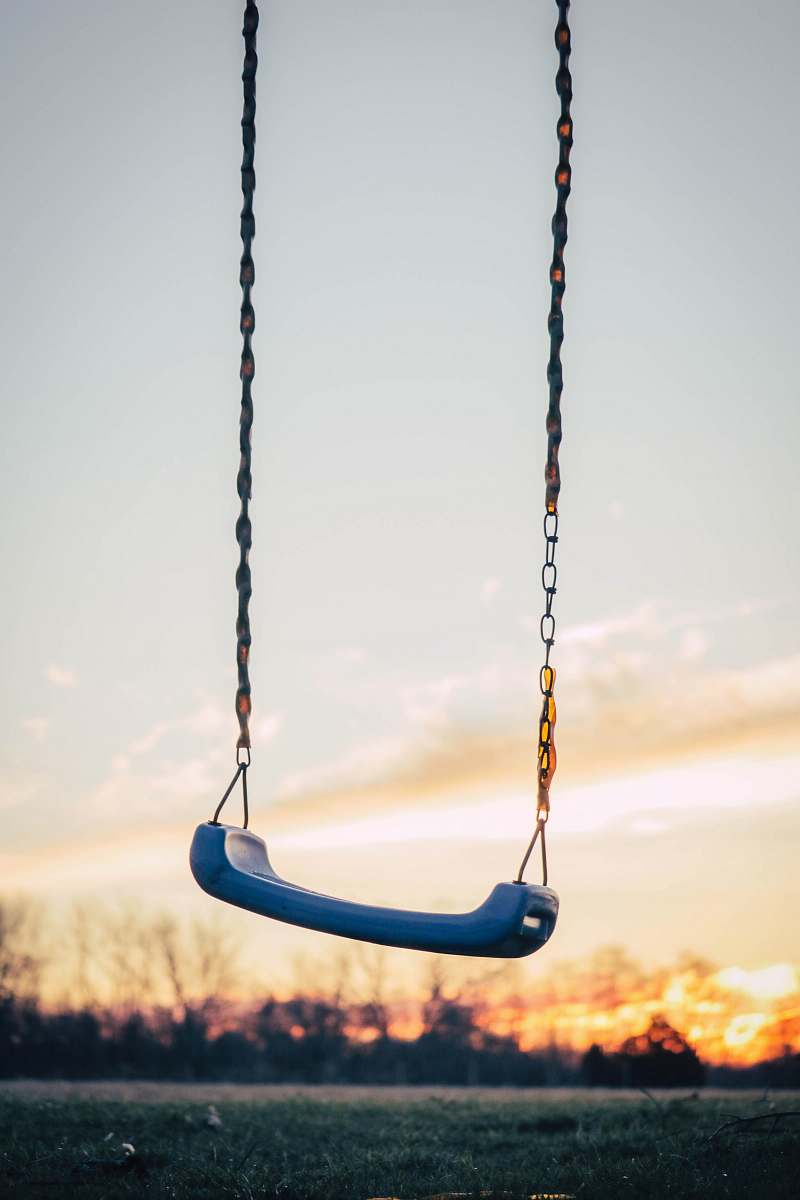 toy selective photography of blue plastic swing chair