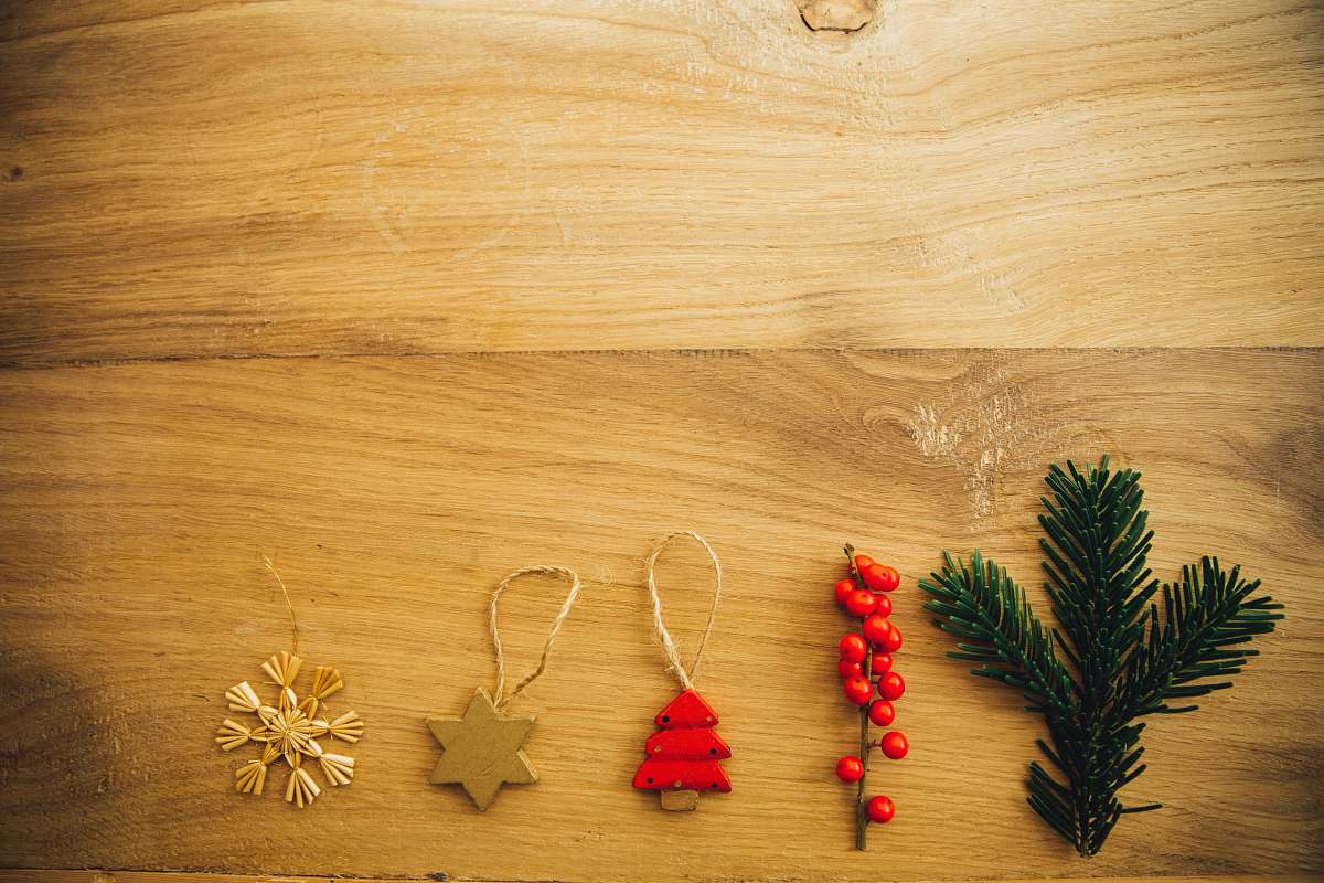 christmas five assorted Christmas tree decors on brown wooden surface foliage