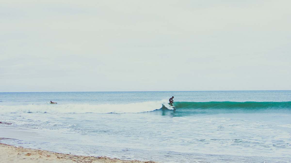 surf person surfing using white surfboard during daytime wave