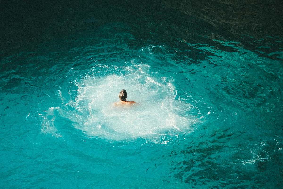 jamaica photo of person swimming on body of water blue