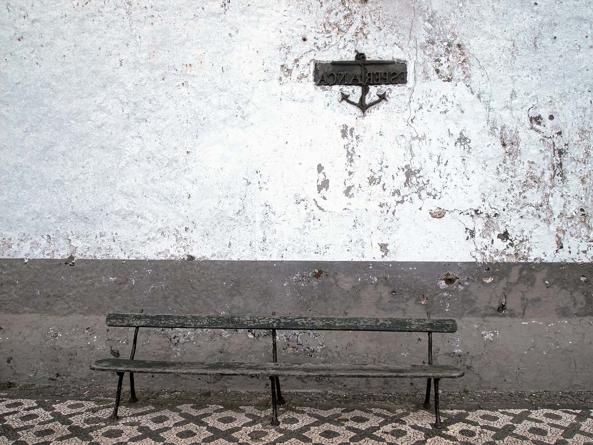 bench brown steel bench beside wall old bench