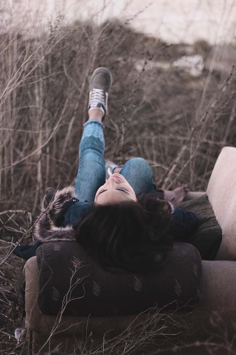 grey woman sitting lying on sofa chair couch