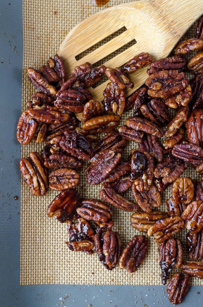 pecan cooked food beside brown wooden ladle grain