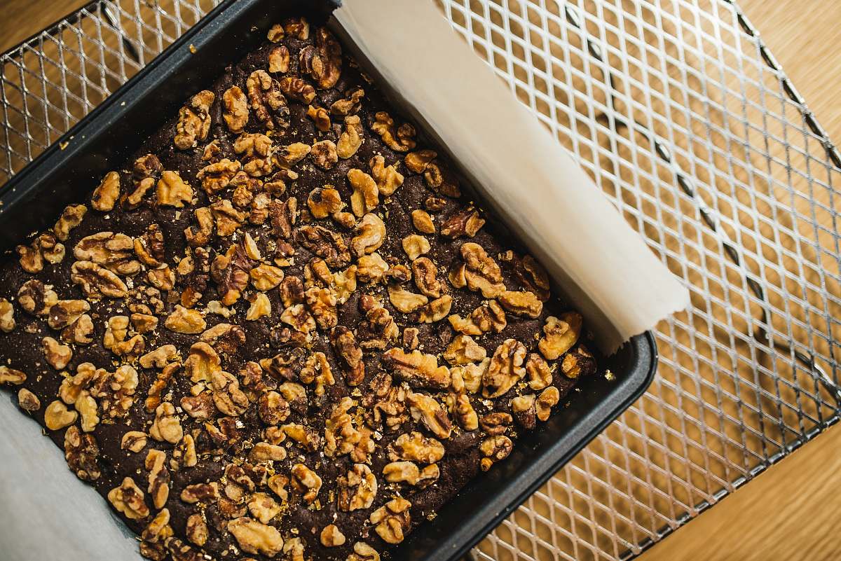 walnut square brown nut cake on black baking pan brownie