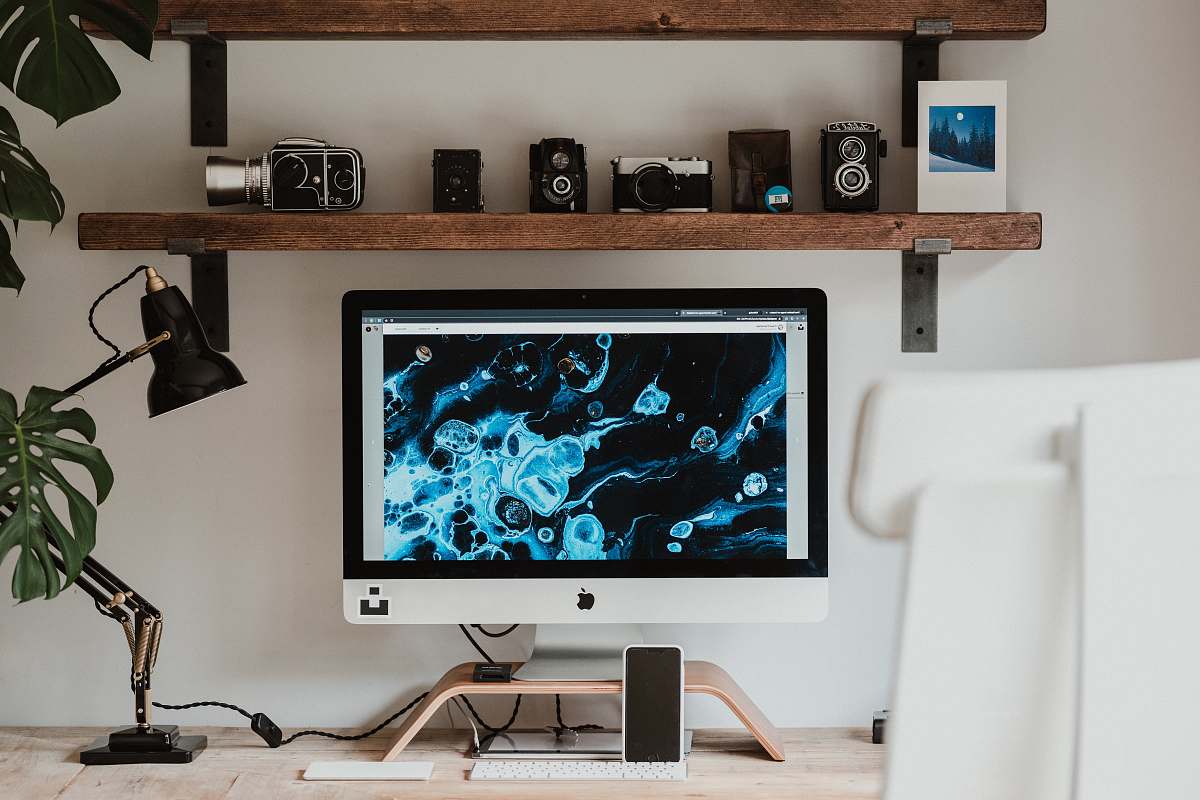indoors silver imac on brown wooden table interior design