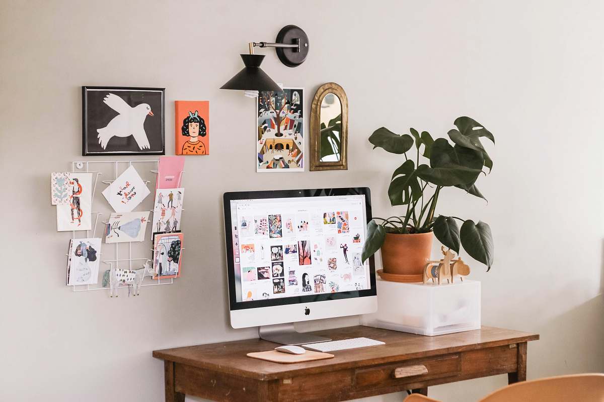 desk silver iMac on wooden desk flora