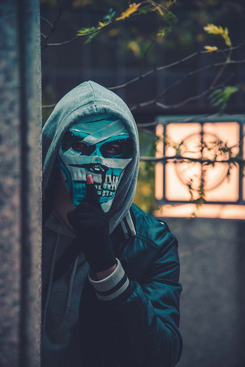 human photo of person wearing mask near barbed wire person