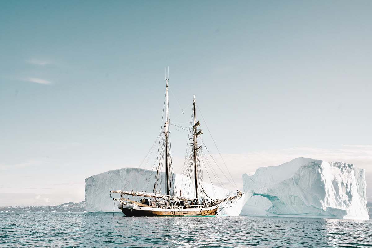 transportation boat approaching iceberg vehicle