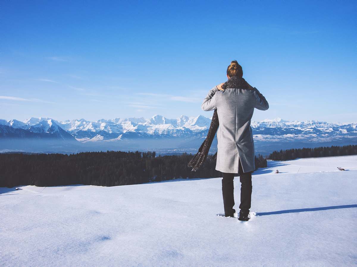 apparel woman standing near trees and body of water \ switzerland