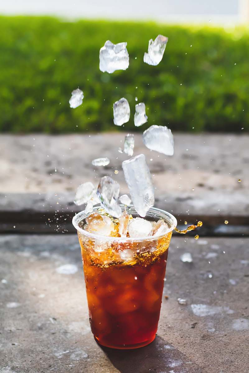 beverage macro photography of dropping ice cube in cup cocktail
