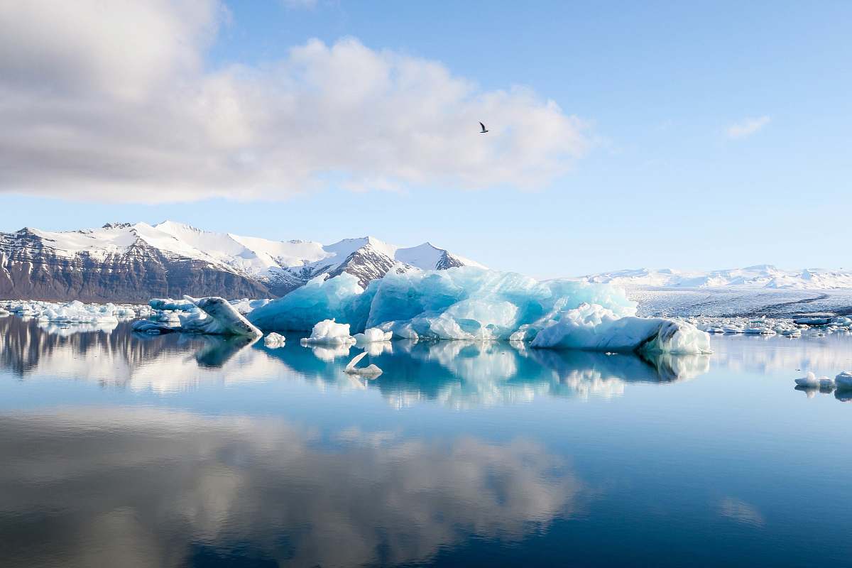 nature ice bergs and alp mountains facing calm body of water ice