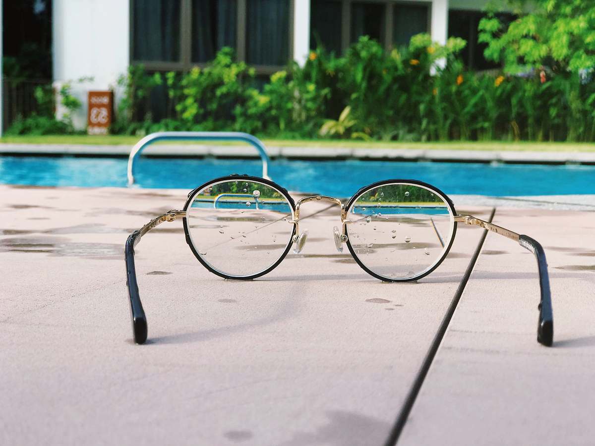 glasses eyeglasses with black frames on white fabric divine