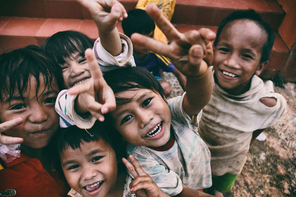 people five children smiling while doing peace hand sign kid