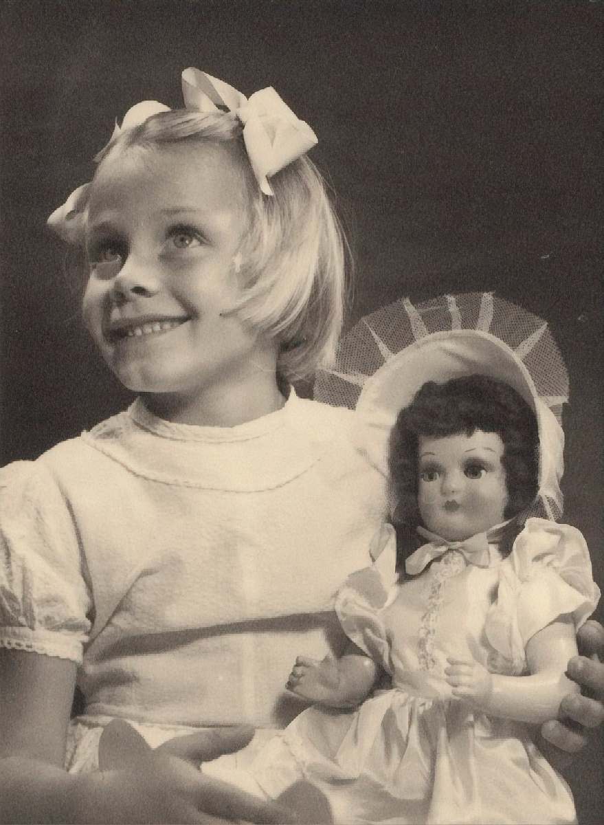 person girl holding doll doll
