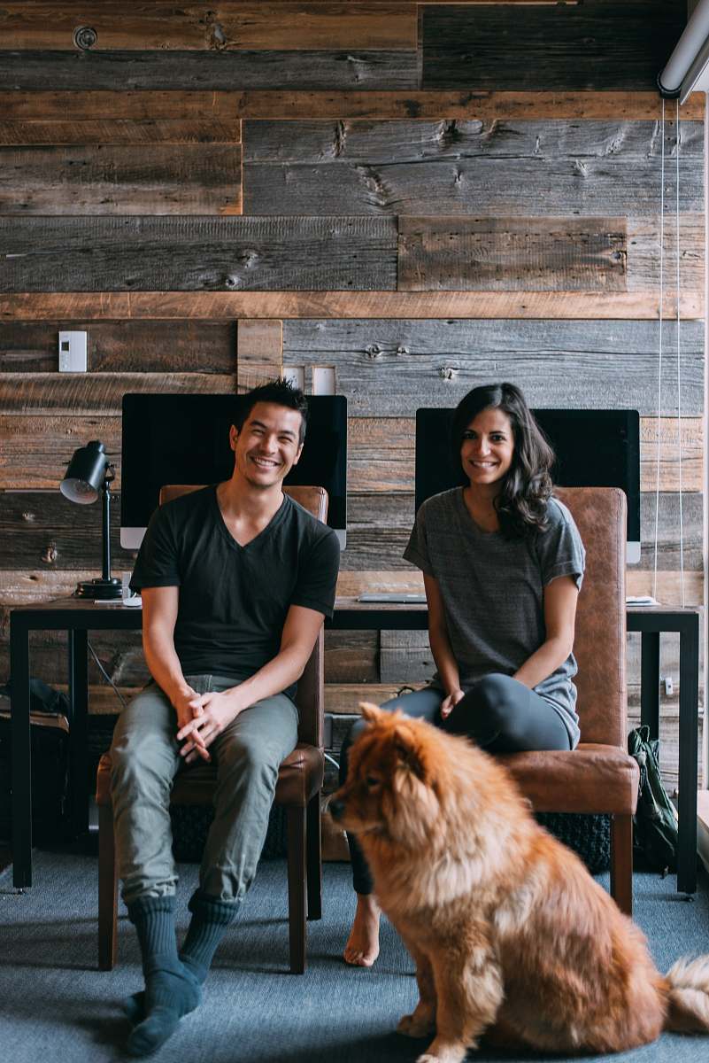 person tan dog sitting beside man and woman people
