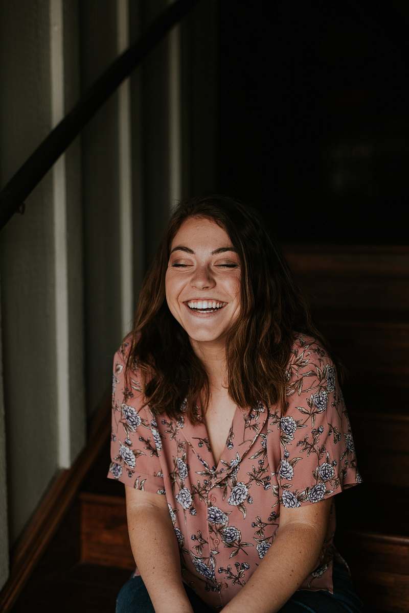people woman sitting on wooden stair smiling person