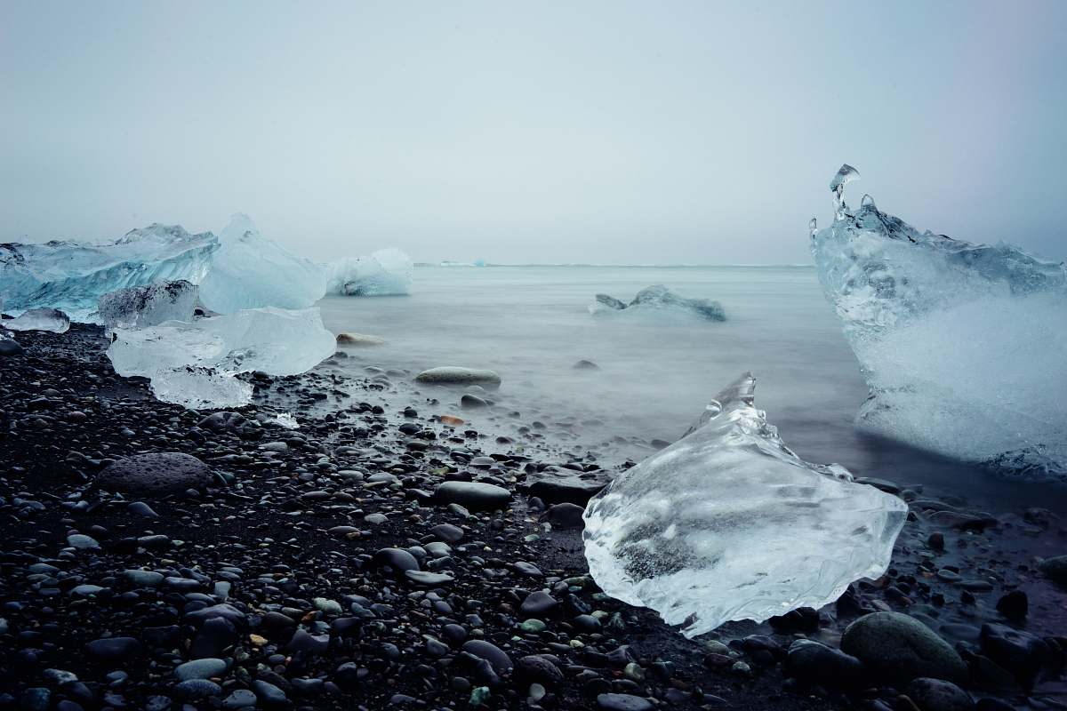 glacier ice blocks on black stone fragment frozen