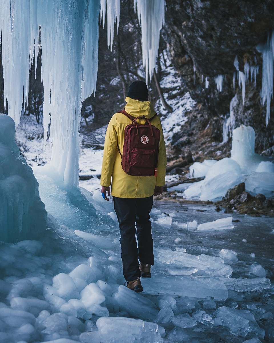 outdoors man carrying red backpack nature