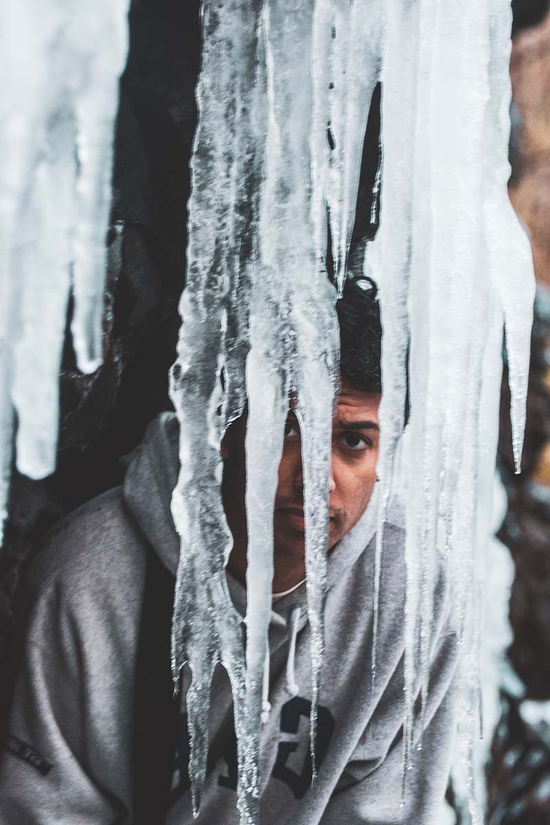 nature man wearing grey pullover hoodie behind ice outdoors
