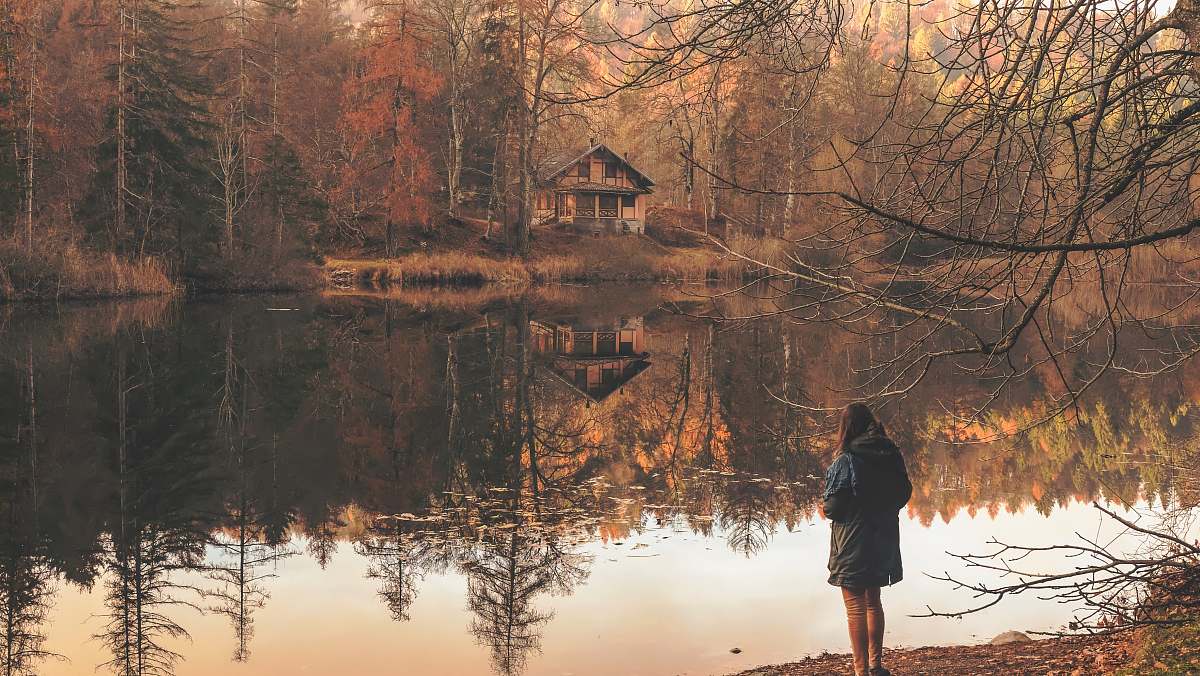 lake girl standing near to body of water reflection