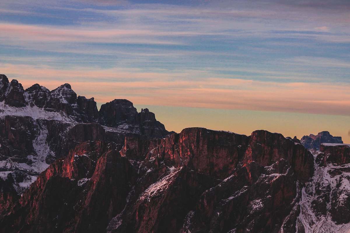 italy brown rocky mountain under blue cloudy sky photo seceda