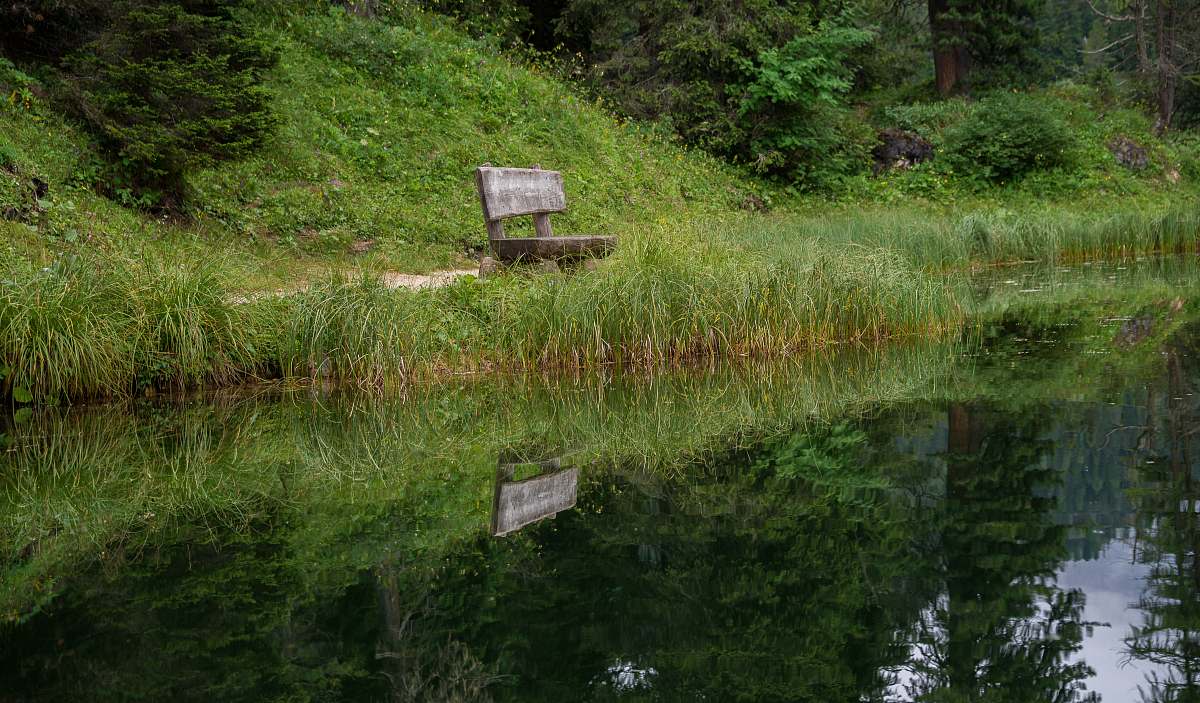 bench bench near body of water during daytime furniture