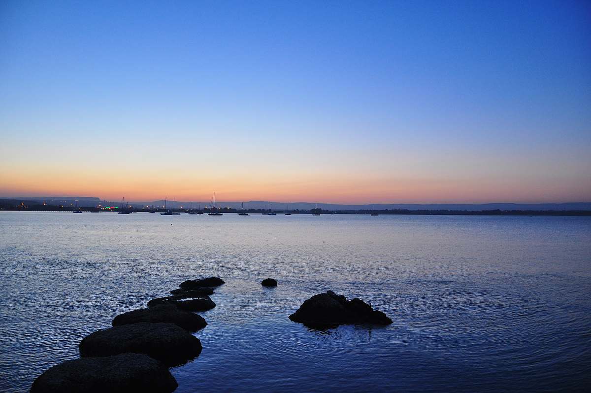 sunset rock formation in water during daytime syracuse