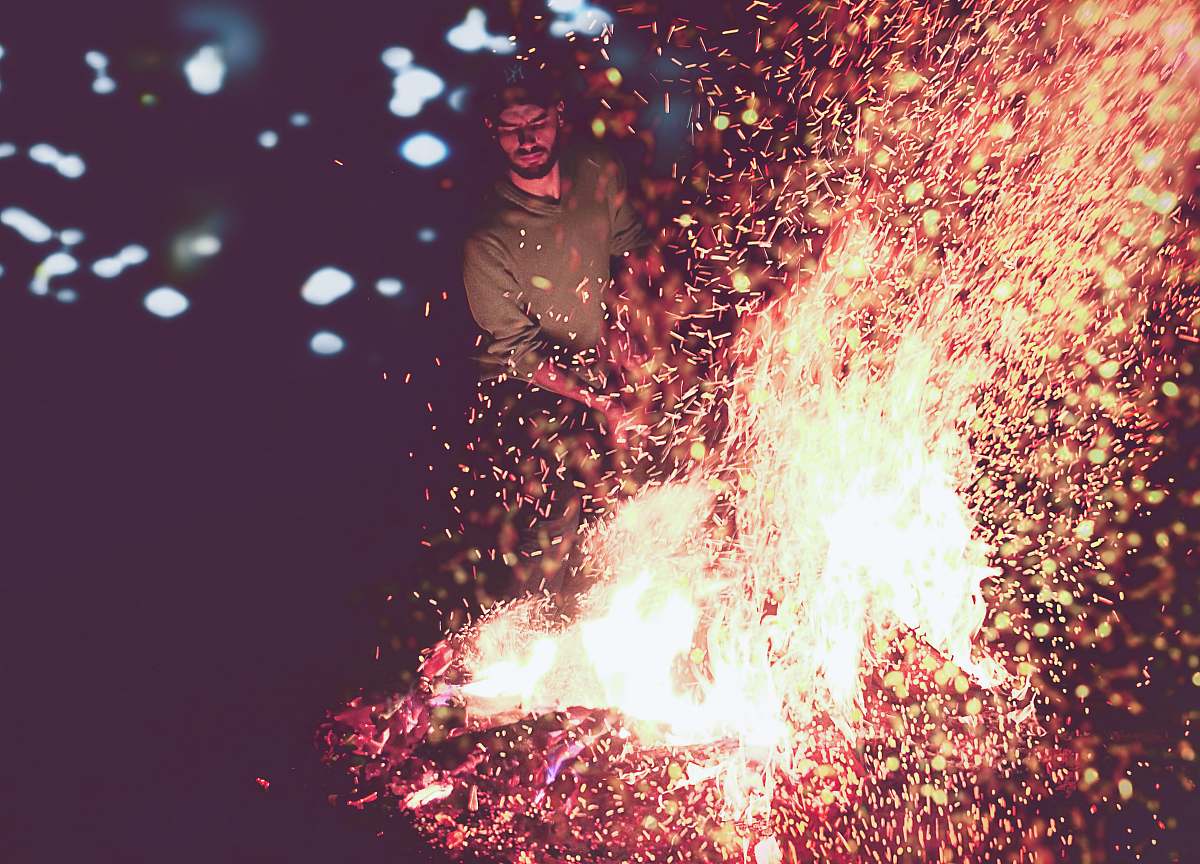 fire man near firewood outdoors