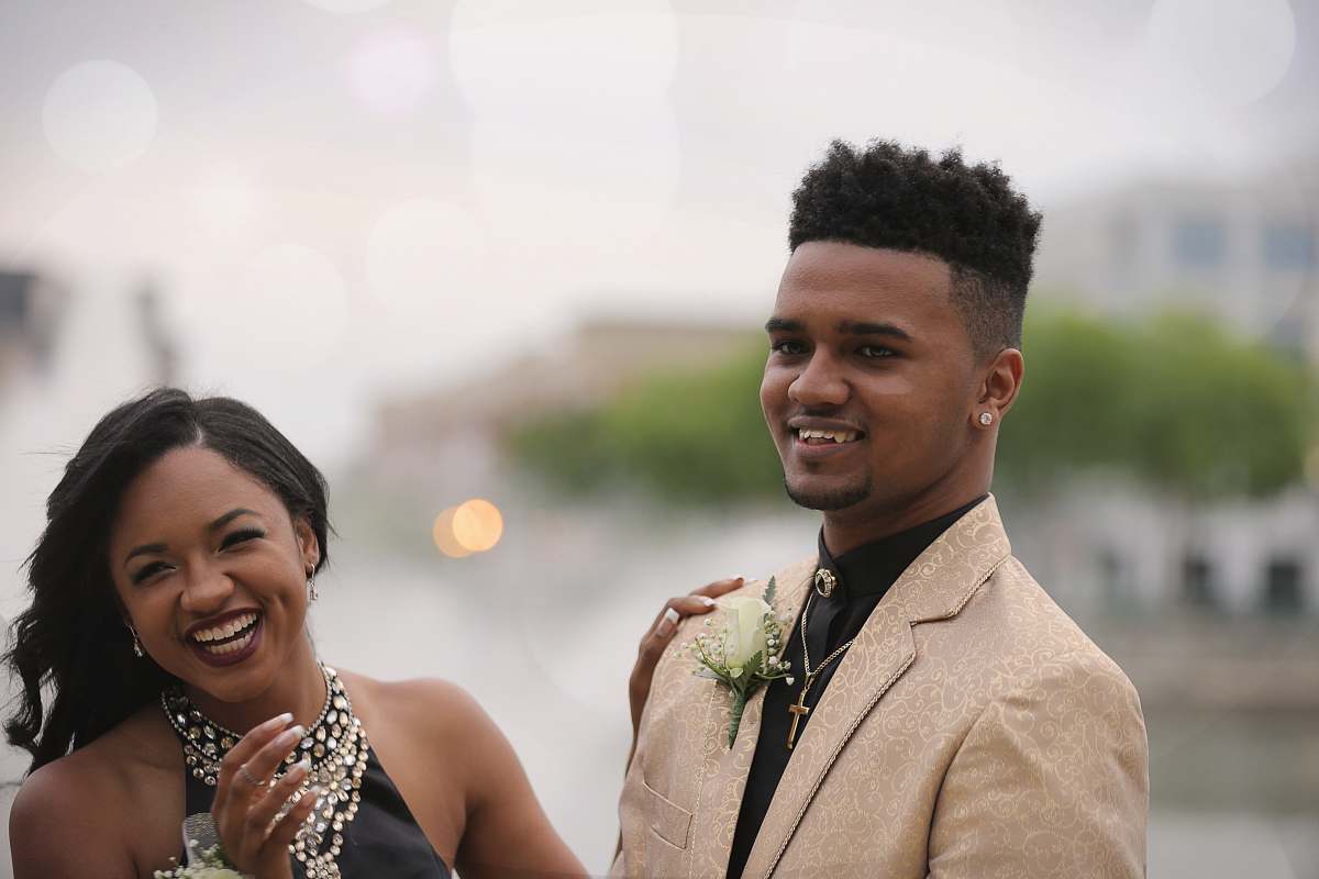 human selective focus photography of man taking photo beside woman couple