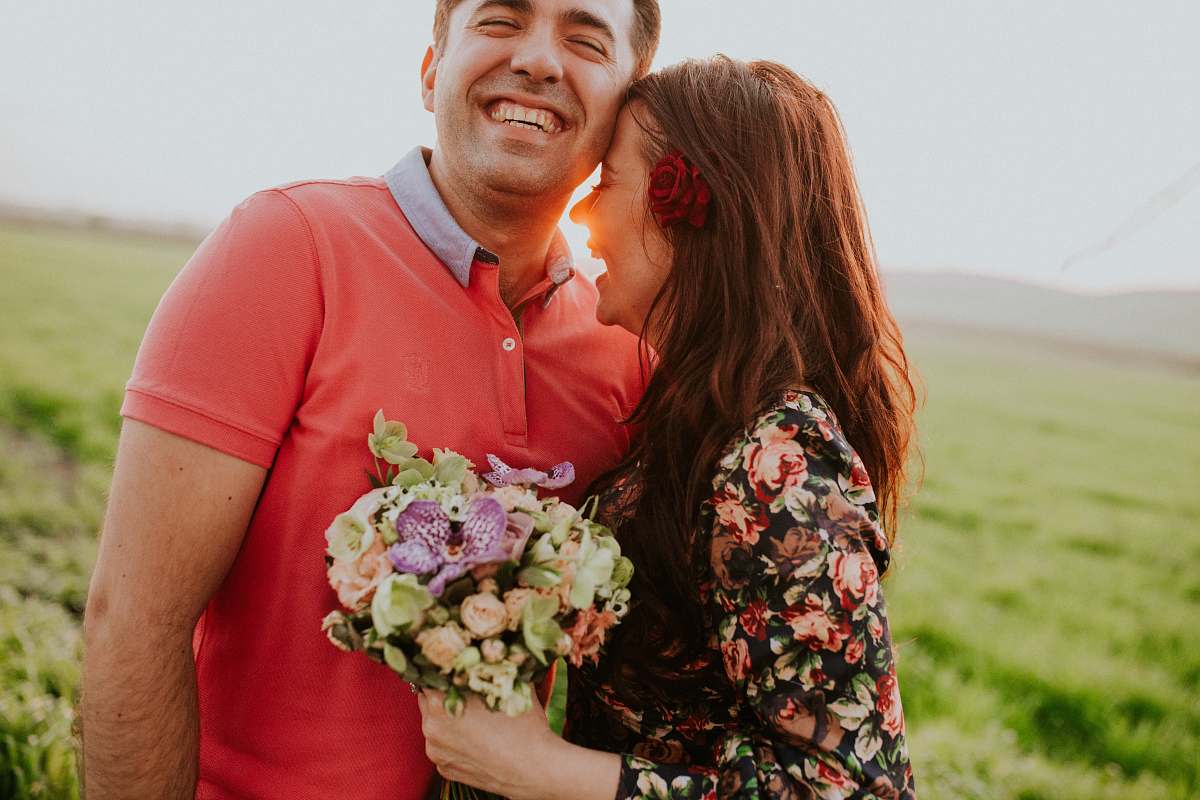 human smiling woman hugging smiling man during daytime couple