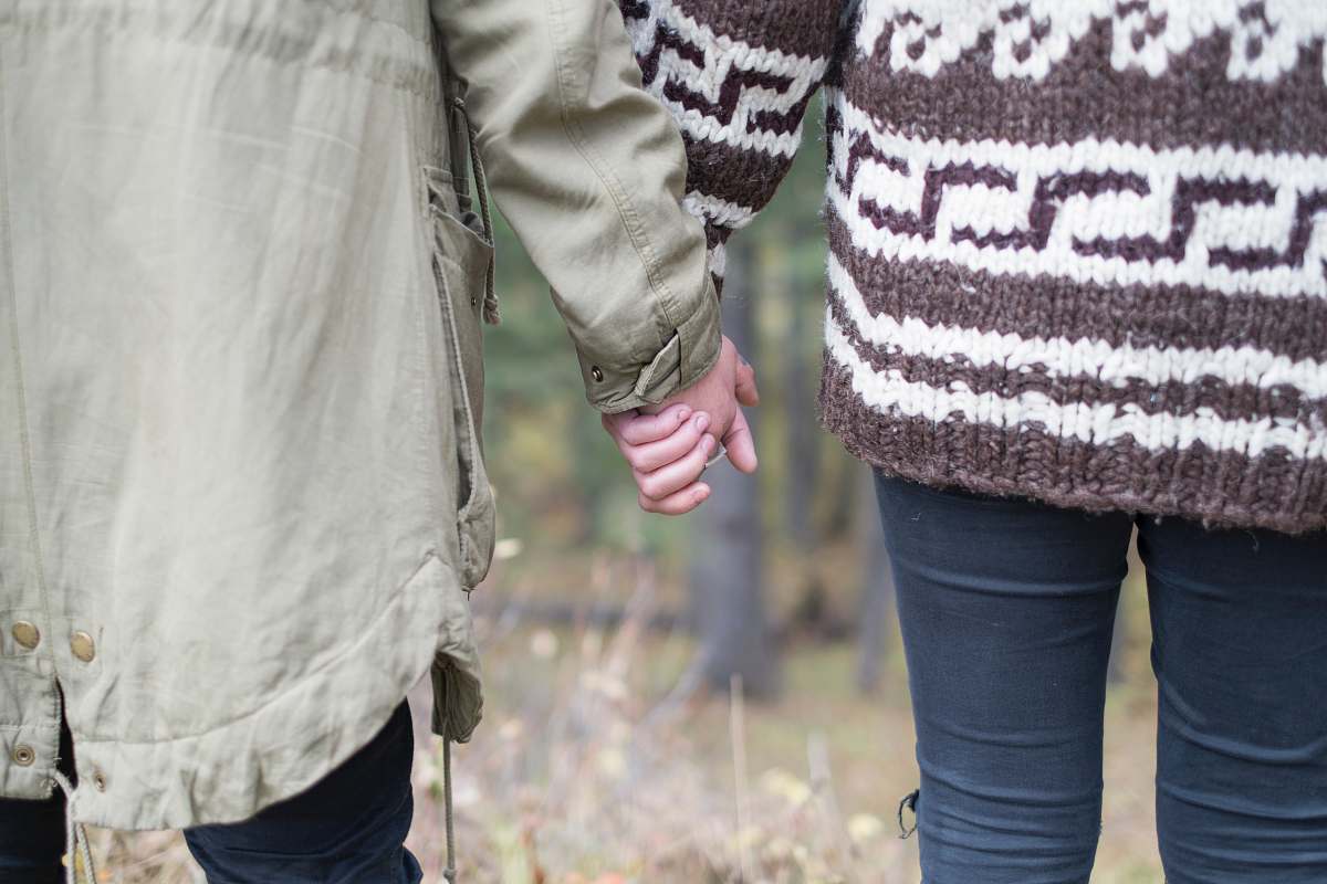 couple two persons holding each other's hands love