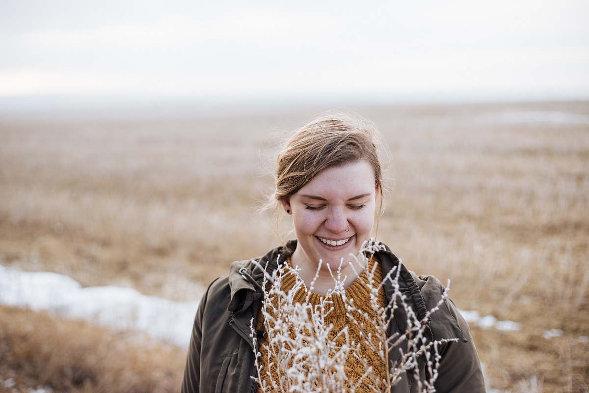 woman woman smiling near flower during faytime female