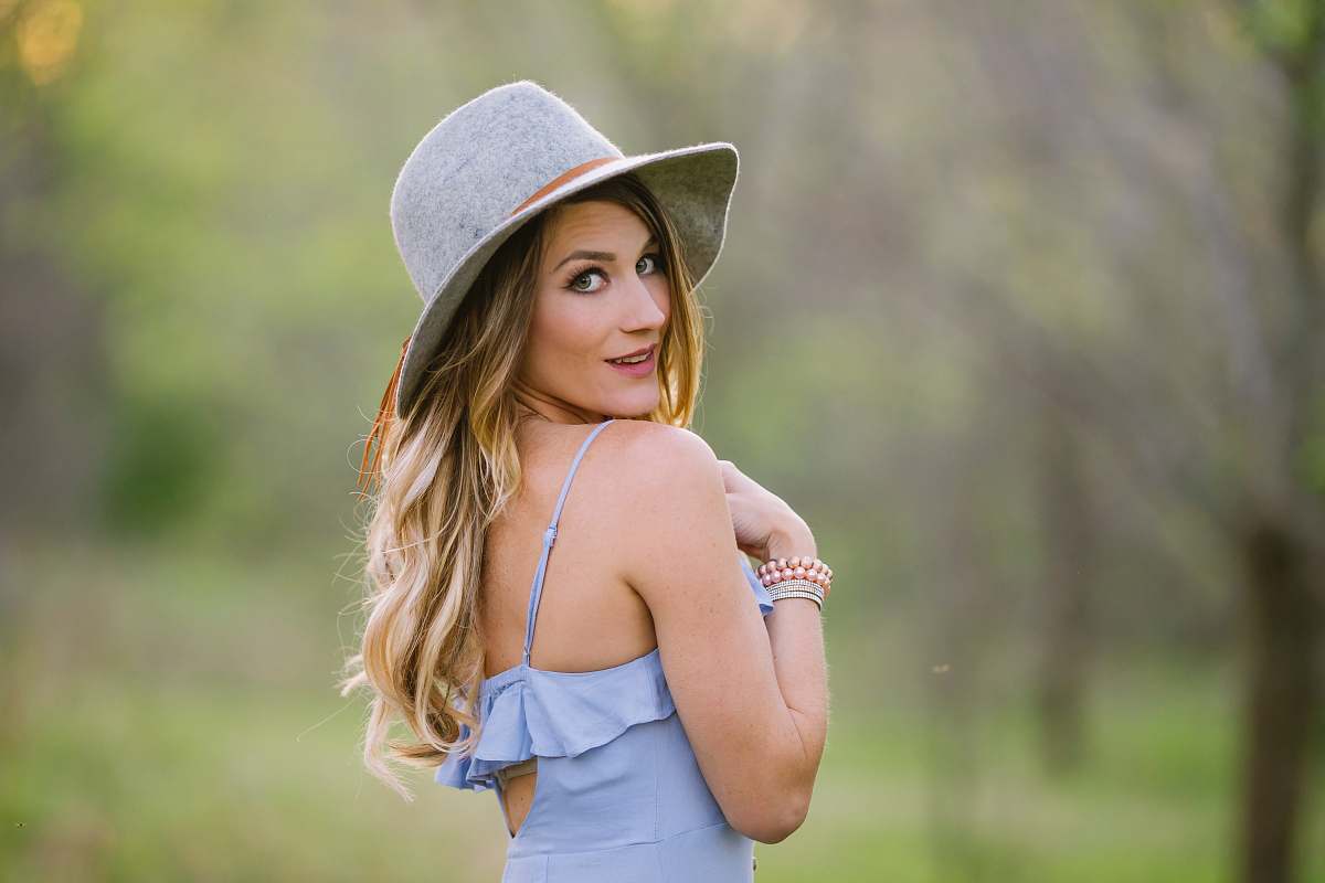 hat shallow focus photography of woman facing sideways during daytime female
