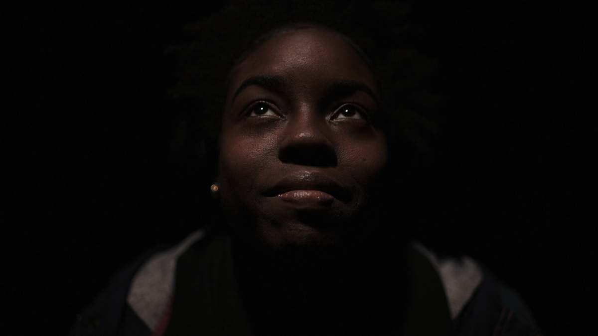 people woman in gray and black shirt surrounded with darkness woman