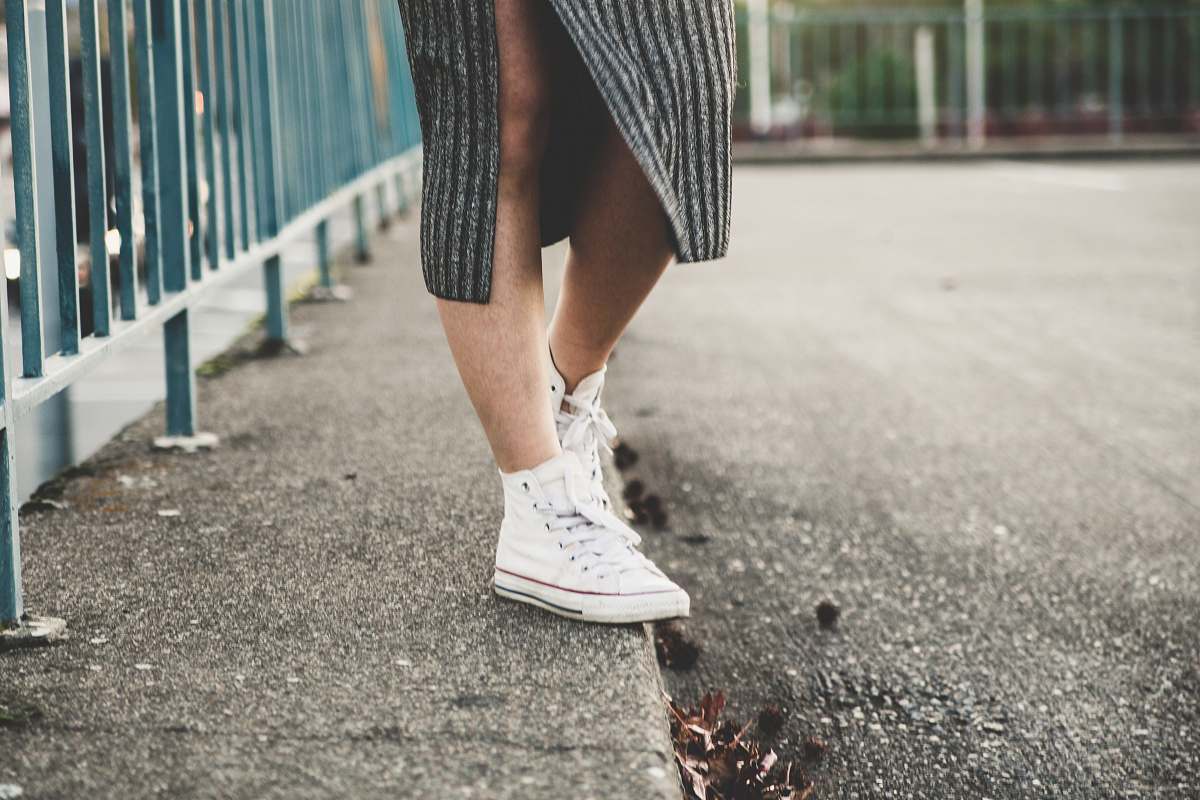 shoe woman standing beside the fence clothing