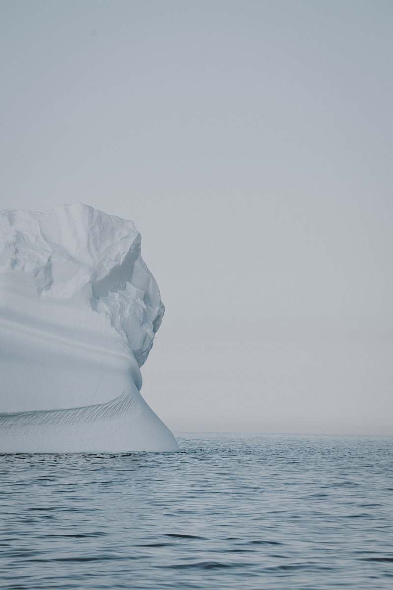 grey selective focus photo of iceberg on large body of water at winter iceberg