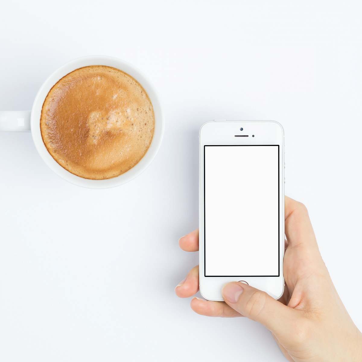  person silver iPhone 5s beside white ceramic mug 