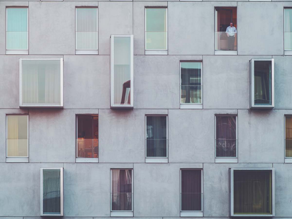 window man standing on tenement door modern