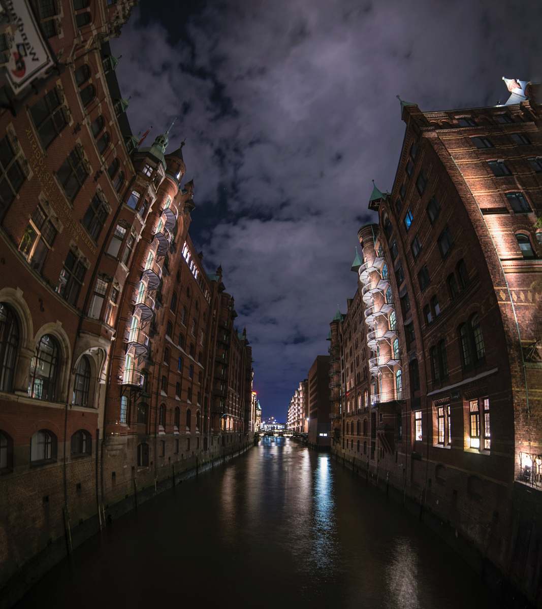 water brown and black concrete building during nighttme speicherstadt