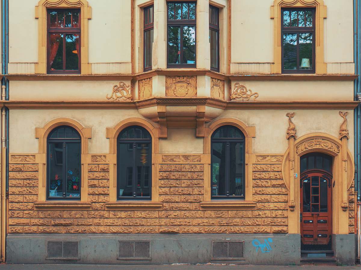 facade closeup photo of yellow concrete house köln